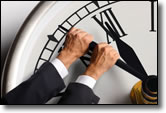 man turning back hands on a clock
