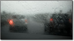 wiper blade streaks on a windshield in a rain storm